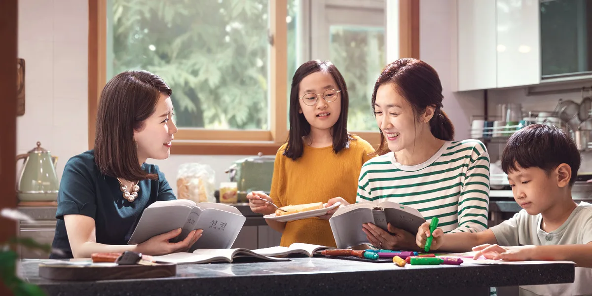 A family studying at the kitchen table
